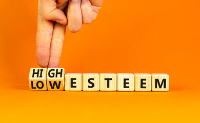 High or low esteem symbol. Concept words High esteem and Low esteem on wooden cubes. Businessman...