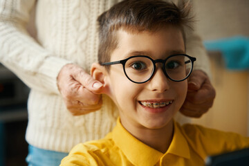 Boy having fun with his granny at home