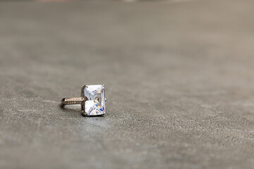 Will you marry me. Wedding ring on concrete stone grey background. Engagement marriage proposal wedding concept. St. Valentine's Day postcard. Banner on valentines day. Copy space