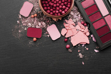 Various makeup products on dark background with copyspace.  New 2023 trending PANTONE 18-1750 Viva Magenta colour