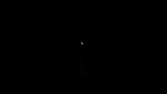 Beacon light rotating at regular intervals with black sky