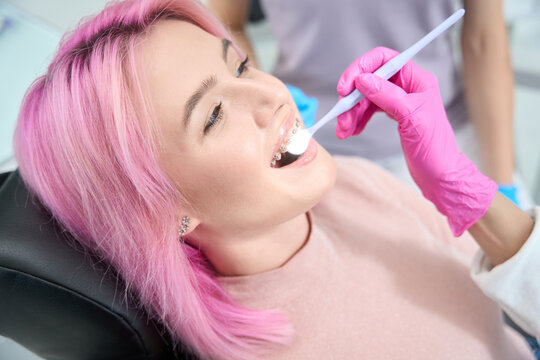 Cheerful young woman at the reception at the dentist