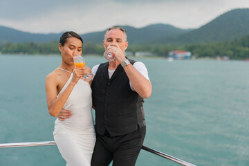 luxury relaxing couple traveler of cruise yacht with background of sea and white sky. Concept business travel. Cruise luxury travel lifestyle businessman and woman on vacation.
