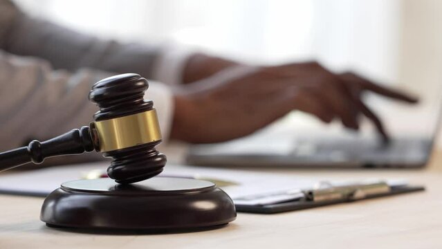 Justice and law concept.Male judge in a courtroom on wooden table and Counselor or Male lawyer working in office. Legal law, advice and justice concept.
