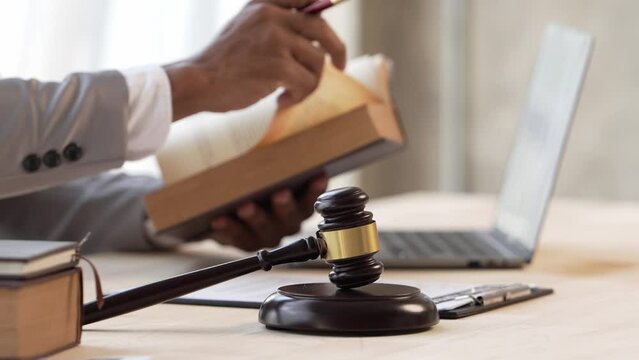 Justice and law concept.Male judge in a courtroom on wooden table and Counselor or Male lawyer working in office. Legal law, advice and justice concept.