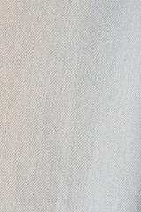 Close up shot of a white colored jeans texture background.