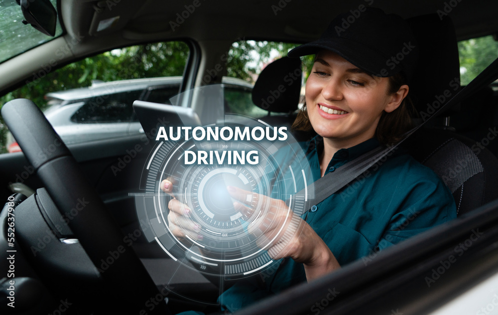 Poster woman driver controls an autonomous car using a digital tablet