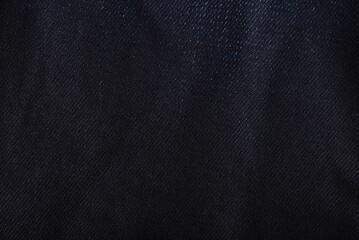 Close up shot of a blue colored jeans texture background.