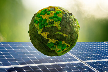 Green planet Earth from natural moss on a background of solar panels. Symbol of sustainable...