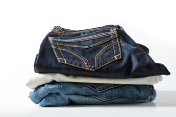 A pile of jeans on a white background.