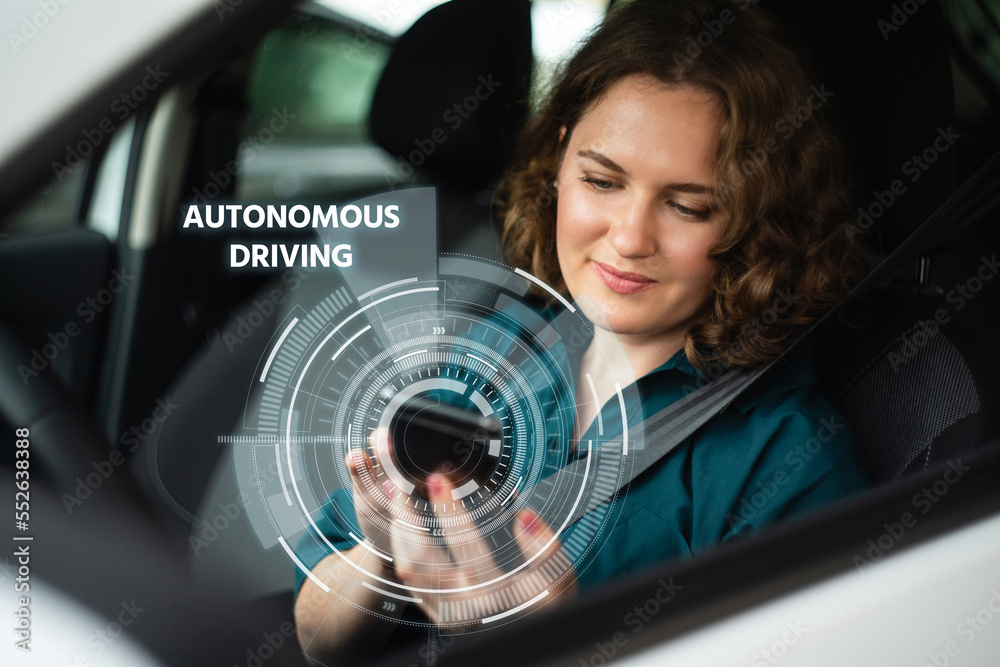 Poster woman driver controls an autonomous car using a smartphone