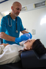 Fototapeta premium Doctor conducts a piece start breathing through an oxygen mask