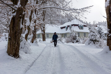 A man walks on a snowy road