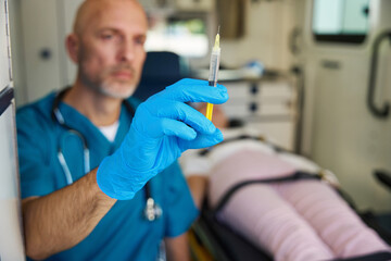 Doctor in medical gloves is preparing to apply an injection