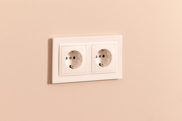 Group of white european electrical outlets on modern beige wall