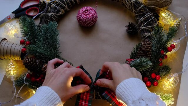 Making a Christmas wreath with your own hands. Holiday preparation, home decoration, New Year	