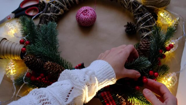 Making a Christmas wreath with your own hands. Holiday preparation, home decoration, New Year	