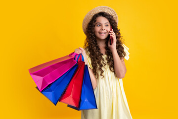 Stylish teen girl with shopping sale bags. Kid holding purchases. Happy teenager, positive and smiling emotions of teen girl.