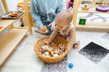 Mother and toddler playing with montessori toys