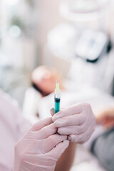 Aesthetic medicine doctor preparing syringe for injection
