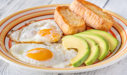 Fried eggs with avocado