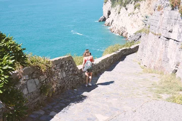 Foto op Plexiglas girl descends from the steps to the sea © daniele