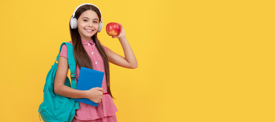 back to school. knowledge day. concept of education. kid in headphones with workbook and apple. Banner of schoolgirl student. School child pupil portrait with copy space.