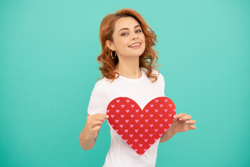 happy young woman with red heart on blue background