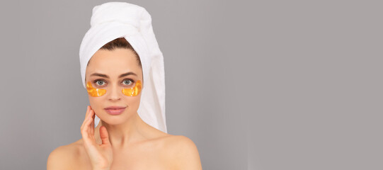 Eye patch. sensual lady with terry towel use facial golden eye patch for skin, spa. Beautiful woman...