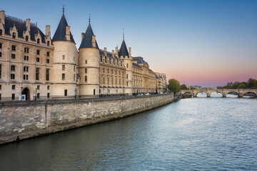 Fototapeta na wymiar The Conciergerie palace and prison by the Seine river at dawn, Paris. France