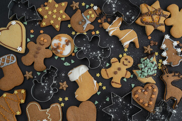 Homemade gingerbread Christmas cookies with icing or frosting and cookie cutters shapes. Xmas Holiday Season winter flat lay composition.