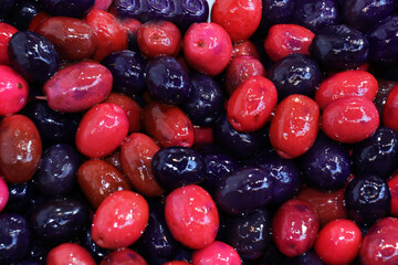 selective focus: olives flavored with forest fruits, colorful flavored olives