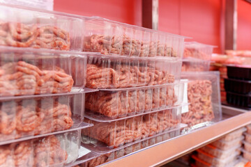 Raw Minced Meat in a transparent Plastic Container, sell in supermarkets. Selective focus