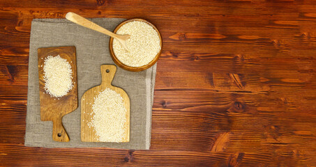 Sesame seed Sesamum indicum, wooden background. The concept of healthy food and drinks. Copy space