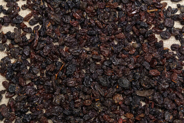 Dried black raisins. Raisins are obtained by dehydrating fresh grapes. Texture