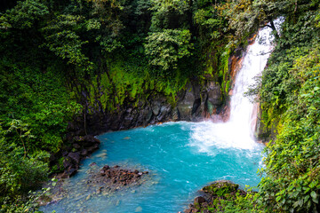 panorama of the famous rio celeste waterfall in volcano tenorio national park in costa rica; a blue waterfall in a tropical rainforest