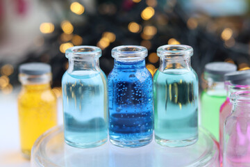 Solutions of blue and green indicator dyes are in three glass jars.