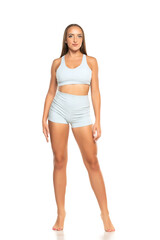 Naklejka premium young barefoot sports woman with long hair in a shorts and top on a white background