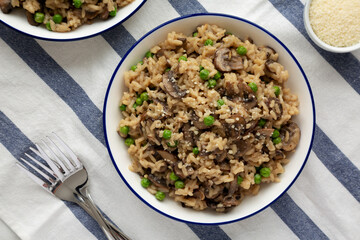 Homemade Mushroom Risotto with Peas on a Plate, top view. Flat lay, overhead, from above.