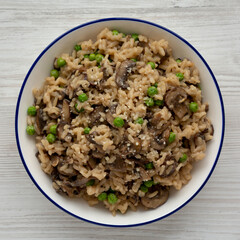 Homemade Mushroom Risotto with Peas on a Plate, top view. Flat lay, overhead, from above.