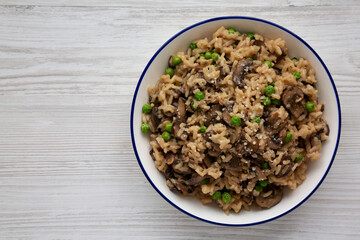 Homemade Mushroom Risotto with Peas on a Plate, top view. Flat lay, overhead, from above. Copy space.