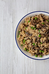 Homemade Mushroom Risotto with Peas on a Plate, top view. Flat lay, overhead, from above. Space for text.
