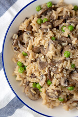 Homemade Mushroom Risotto with Peas on a Plate, top view. Flat lay, overhead, from above. Close-up.