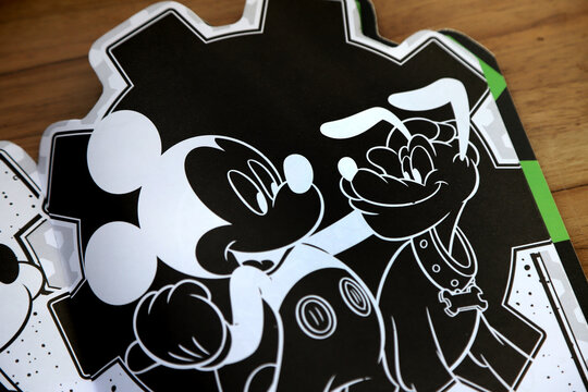 Disney coloring magazine. Mickey Mouse and Pluto in their classic outfits. Black background and white lines.