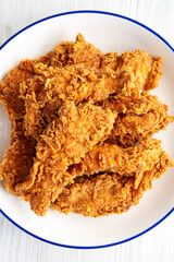 Homemade Chicken Strips with Mustard and BBQ on a Plate, top view. Flat lay, overhead, from above. Close-up.