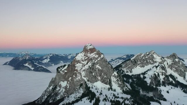 Insane scenery in the middle of Switzerland in the canton of Schwyz. This beautiful aerial view was captured with a DJI drone. Epic sunrise with a beautiful pink sky on the horizon.