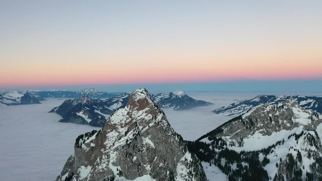 Epic flight around a majestic mountain called Grosser Mythen in beautiful Switzerland. Beautiful drone shot in a really beautiful winter landscape.What a beautiful day with a sea of ​​fog.