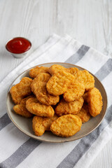 Homemade Chicken Nuggets with Ketchup, side view.