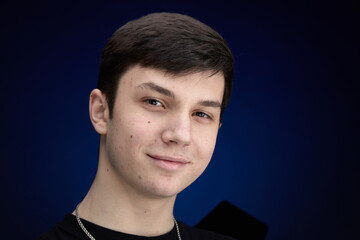 Portrait of a brunette teenager joyful portrait close-up pimples moles hairs problematic skin.