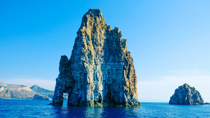 Aeolian Islands, Sicily. Sea stacks at Lipari island, and Vulcano island in the background.